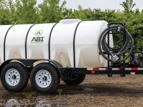 A sprayer trailer with a large tank attached, ready for agricultural use