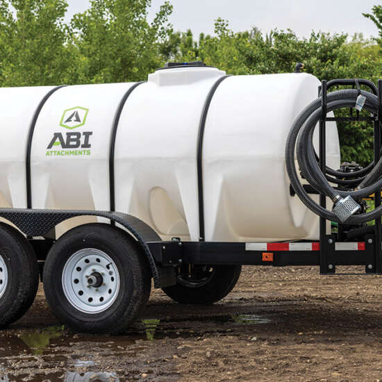 A sprayer trailer with a large tank attached, ready for agricultural use