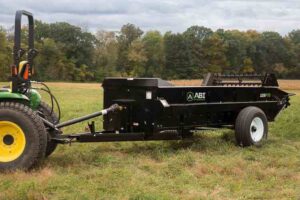 Tractor pull behind 125 PTO Manure Spreader being displayed.