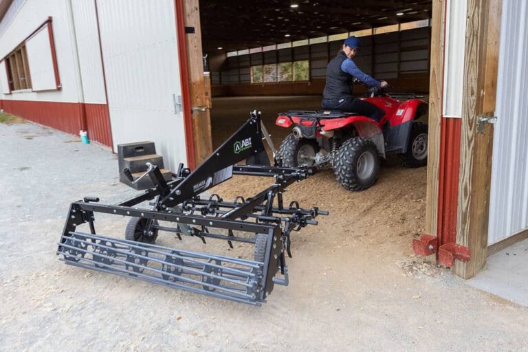 SportPro M1 being dragged by a ATV/UTV nto a indoor synthetic footing arena.