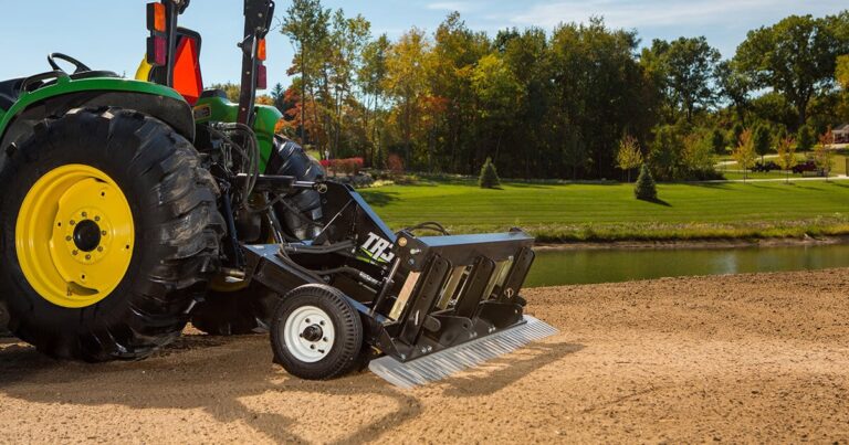 TR3 in front of water and landscaping.