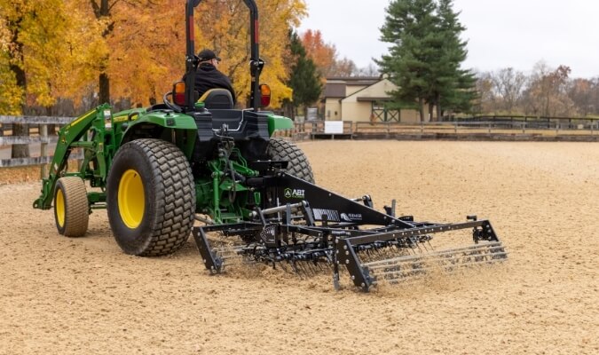 Synthetic footing arena drag being used in the daylight.