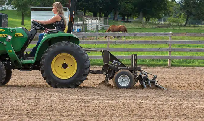 TR3 arena drag being used and draggd by a green tractor.