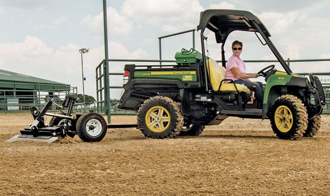 Arena Drag attached to a green UTV/ATV.