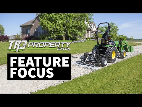 The words ‘TR3e Property Edition – Feature Focus+’ appear in bold white font. The background shows a house and trees, with the TR3e Property Edition displayed behind a tractor.