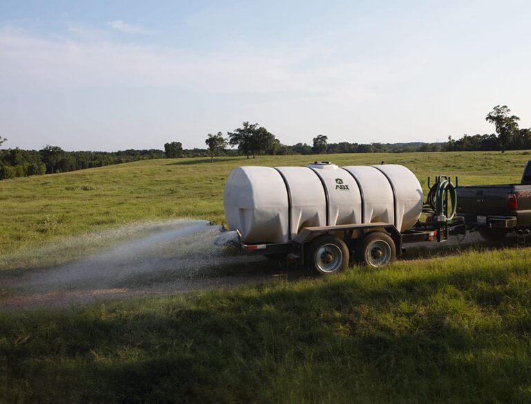 ABI Water Trailer spraying water in grass.