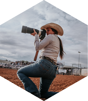 Hailey Rae taking a photo, on her knee.