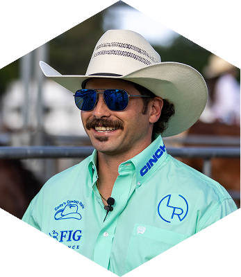ABI Pros Ambassador Hex - Jordan Spears - He is smiling to the side while wearing a blue shirt with a cowboy hat.