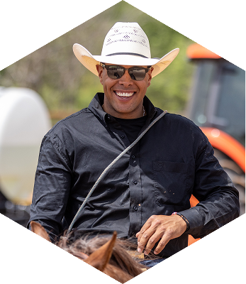 ABI Pros Ambassador Hex - Shad Mayfield - He is riding a horse with a black shirt on and wering a cowboy hat.