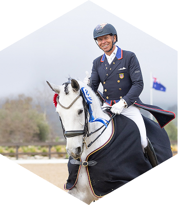 ABI Pros Ambassador Hex - Steffen Peters - He is riding a horse and is nicely dressed.