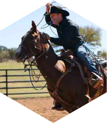 ABI Pros Ambassador Hex - Trevor Brazile - He is riding a horse with a rope in his hand.