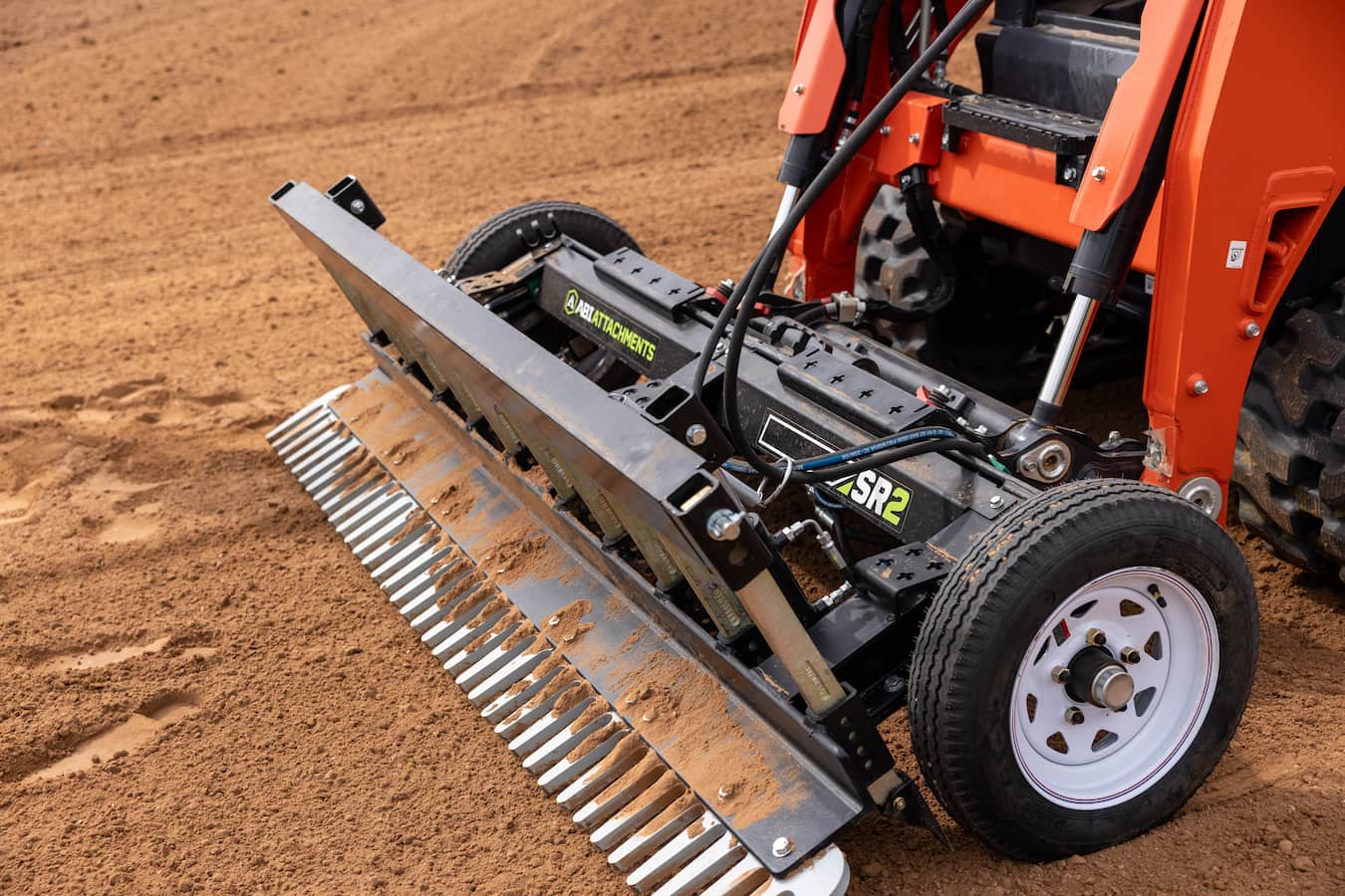 Shad Mayfield using an ABI Attachments SR2 with a skid steer - front view angle